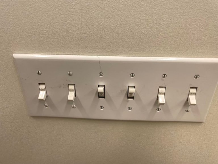 Large 6-count light switches mounted on the wall.