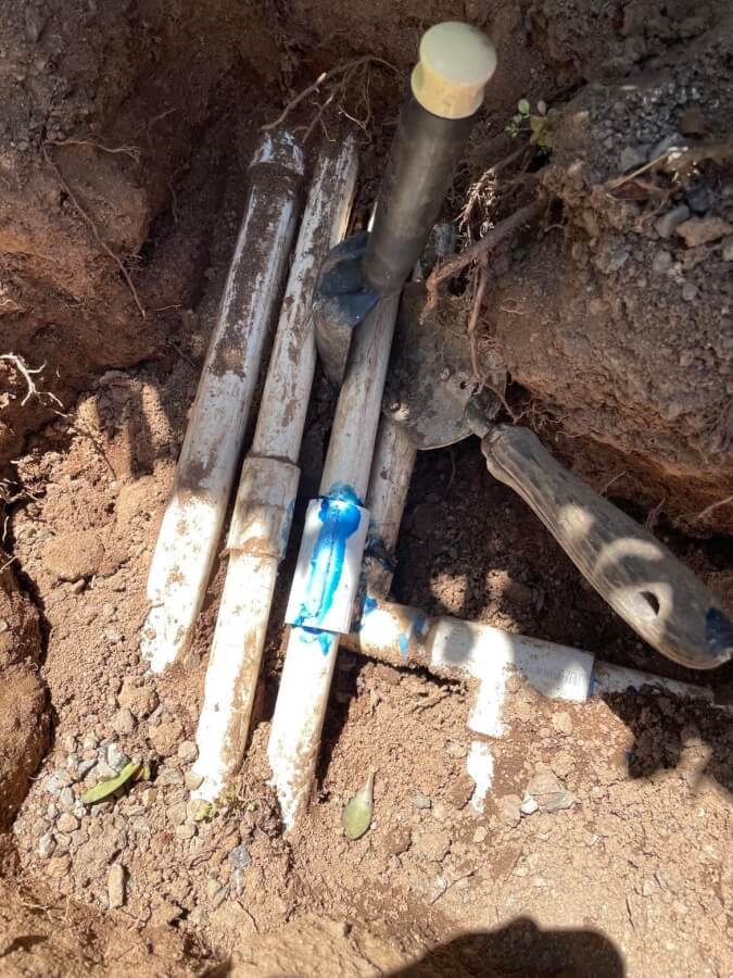 White plastic pipes for irrigation system. The cracked one is just fixed.